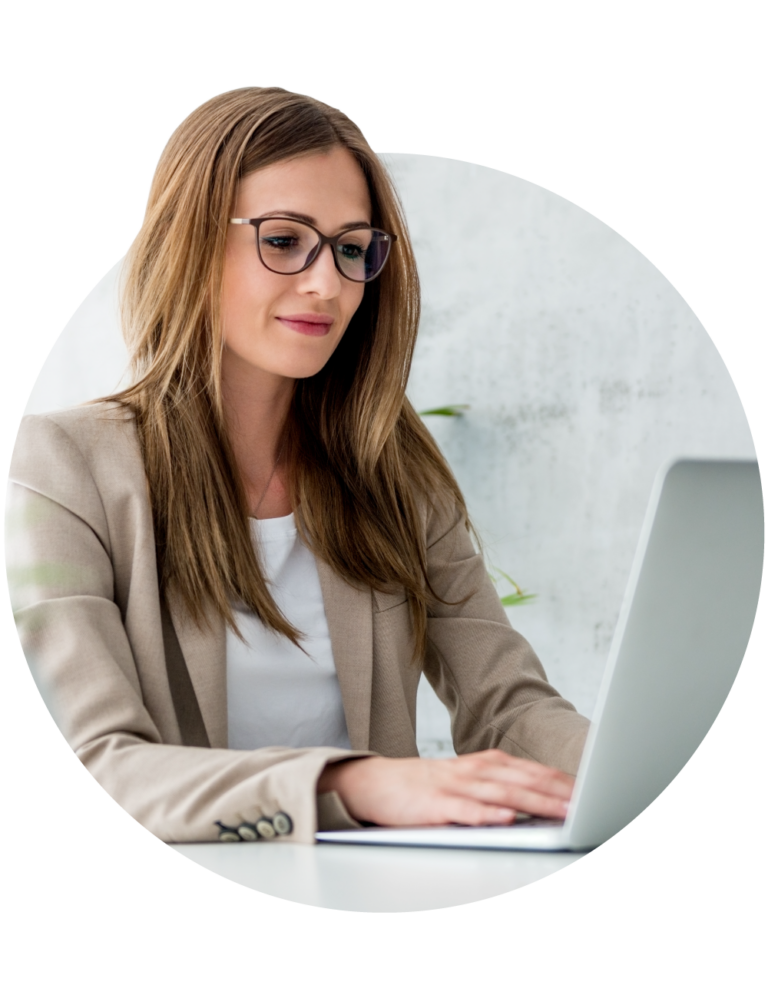 A professional woman on her laptop looking up something for her job.